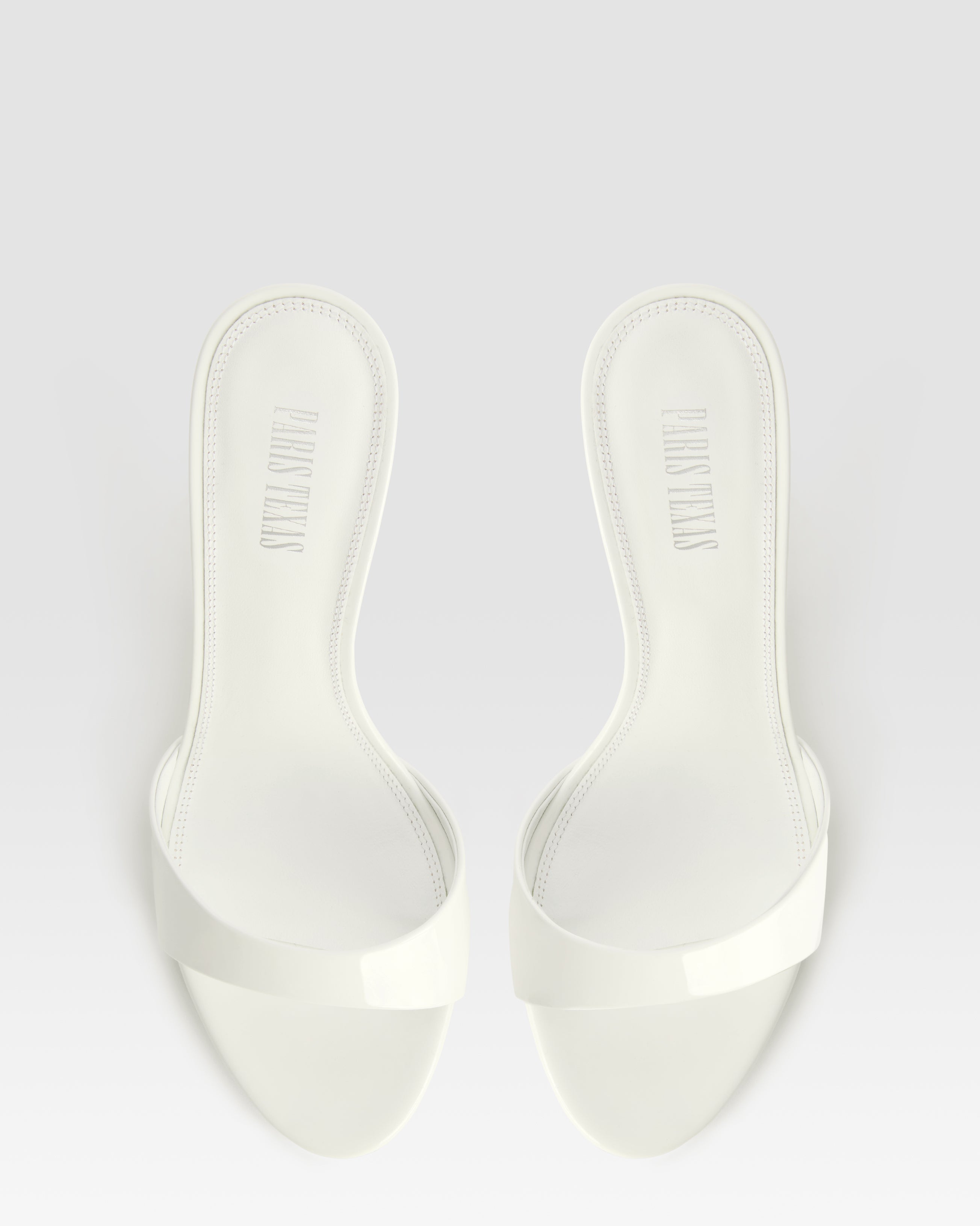 Mules in optic white patent leather