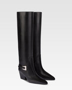 Long, pointed knee-high boots in smooth black leather