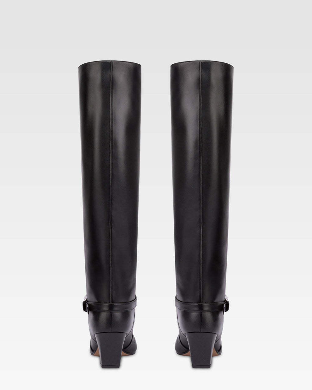 Long, pointed knee-high boots in smooth black leather