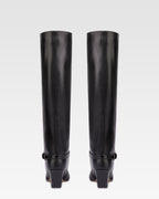 Long, pointed knee-high boots in smooth black leather