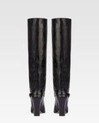 Tall, knee-high boots in shiny black vintage leather