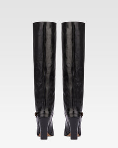 Tall, knee-high boots in shiny black vintage leather