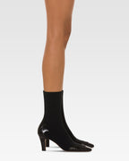 Boots in black croco-embossed and stretchy leather