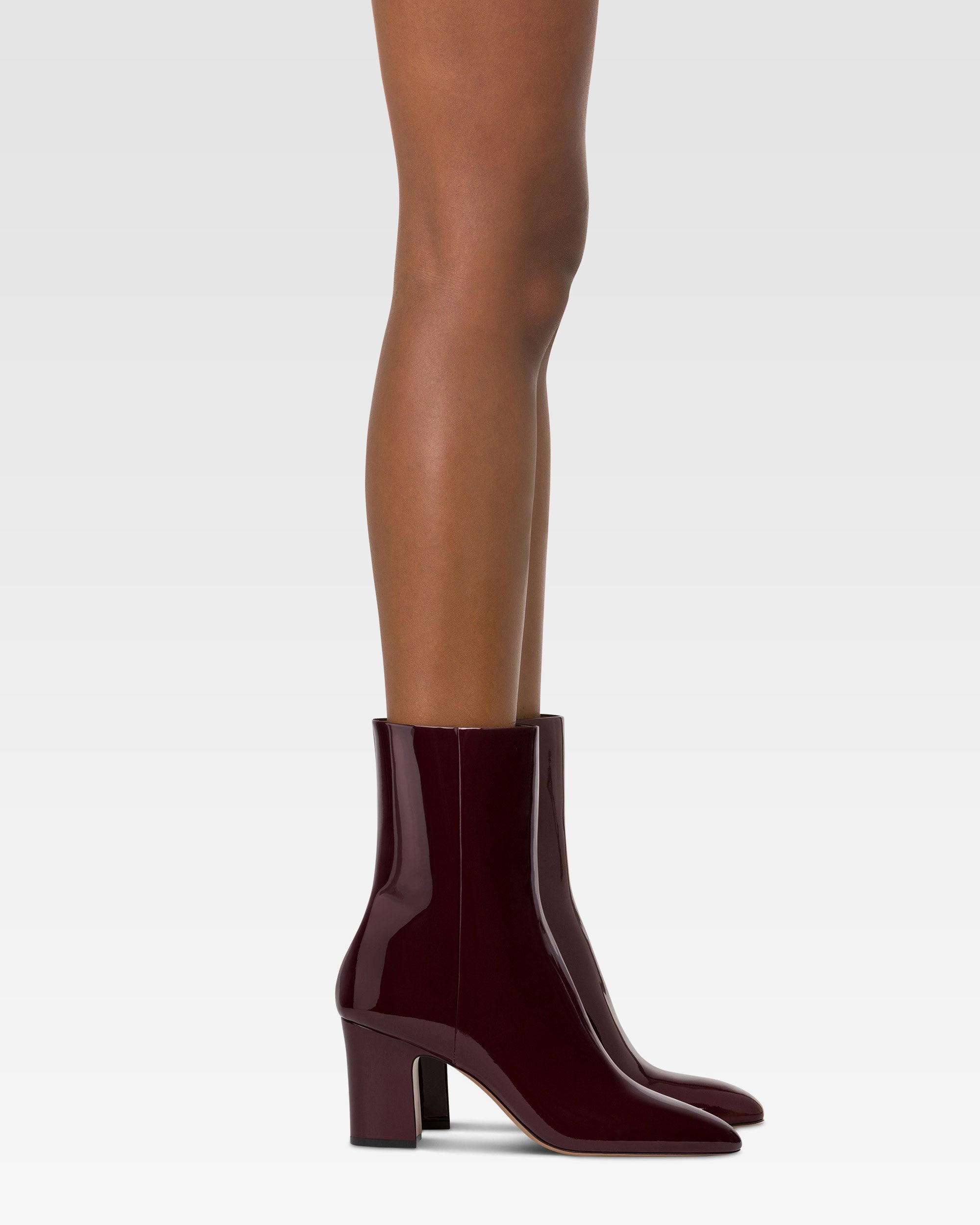 Ankle boots in rouge noir patent leather.