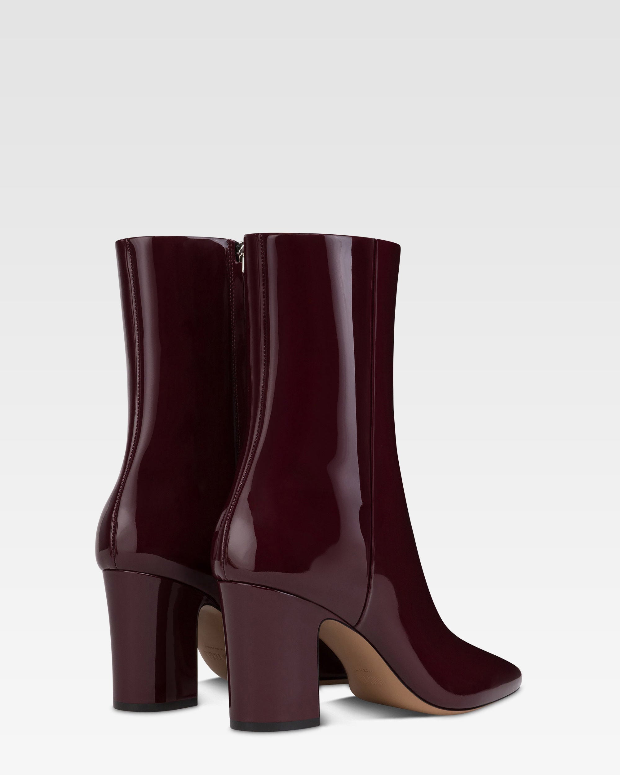 Ankle boots in rouge noir patent leather.