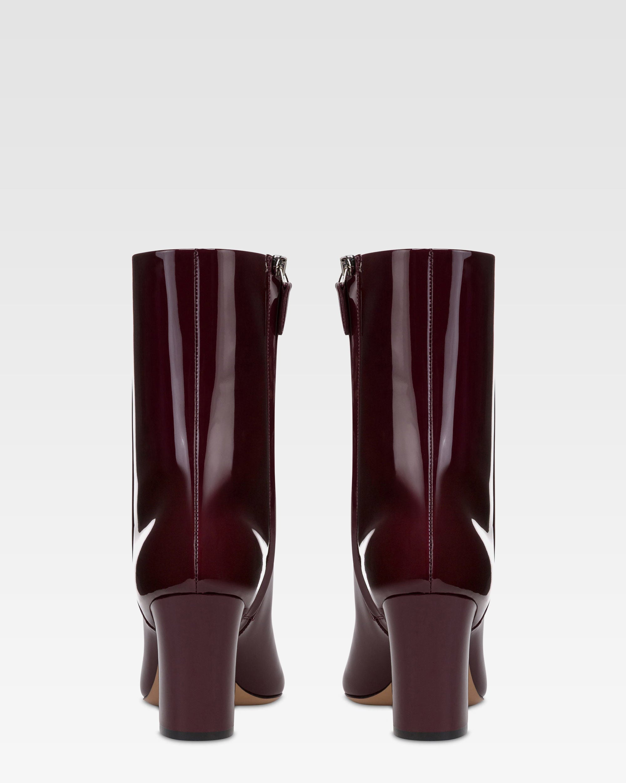 Ankle boots in rouge noir patent leather.