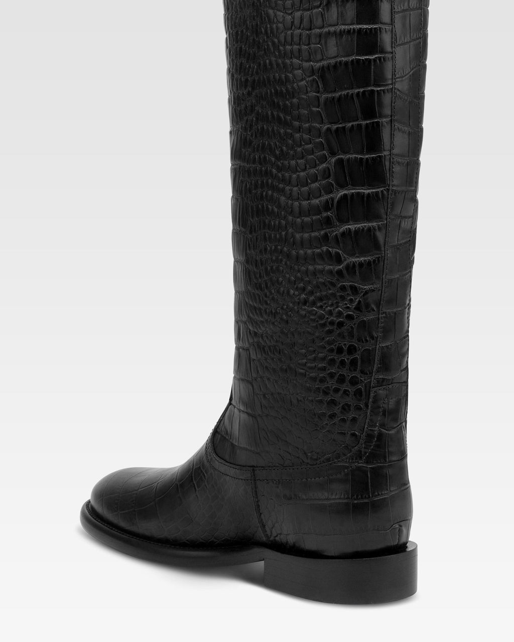 Boots in black croco-embossed leather