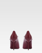 Pumps in rouge noir patent leather