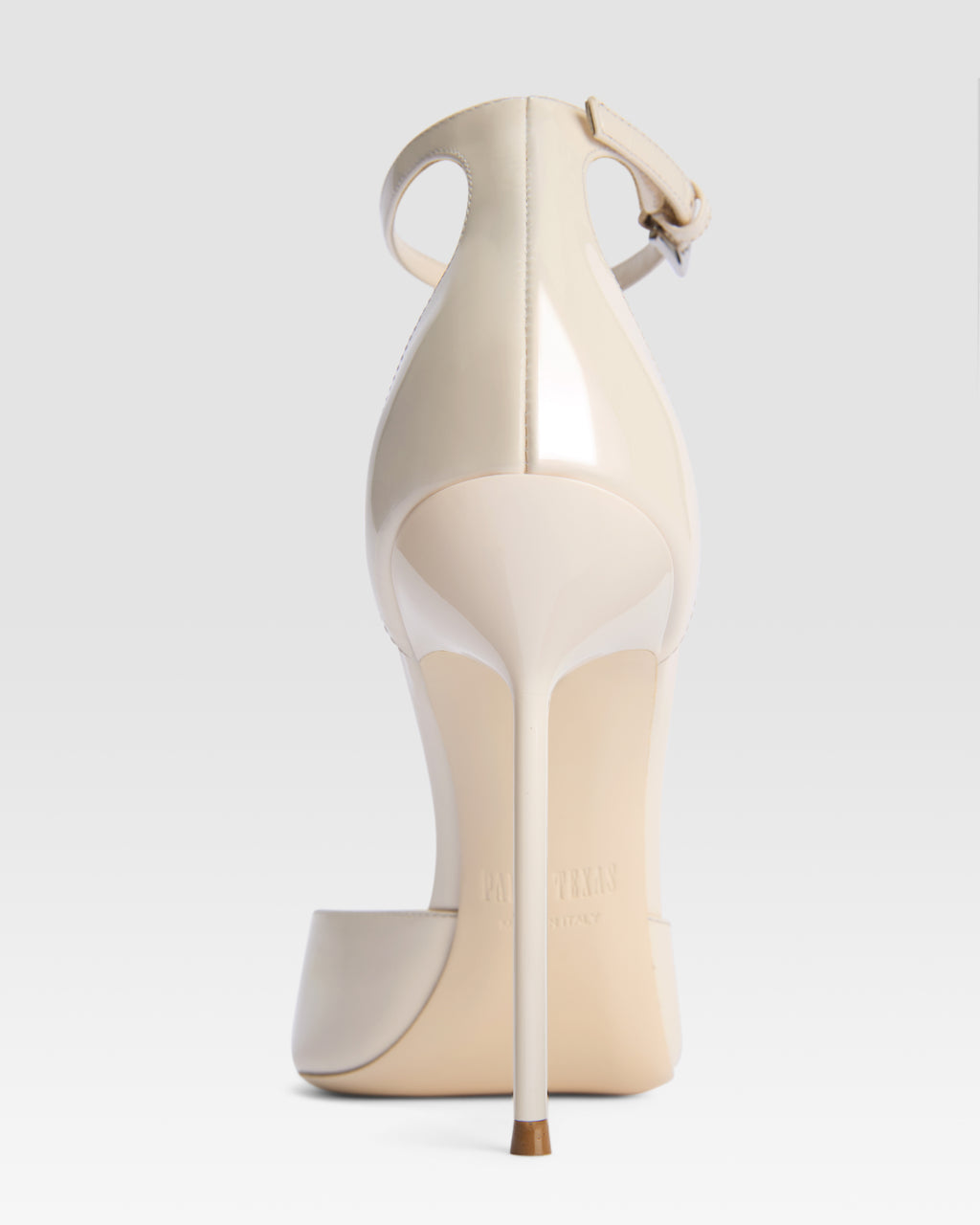 Ankle-strap pumps in ivory patent leather
