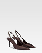 Slingbacks in ebony satin with stud detailing.