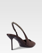 Slingbacks in ebony satin with stud detailing.