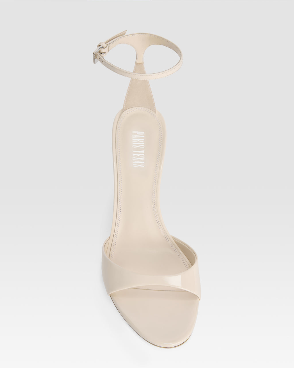 Ankle-strap sandals in ivory patent leather