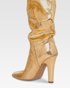 Over-the-knee boots in gold, metallic-effect printed python leather.