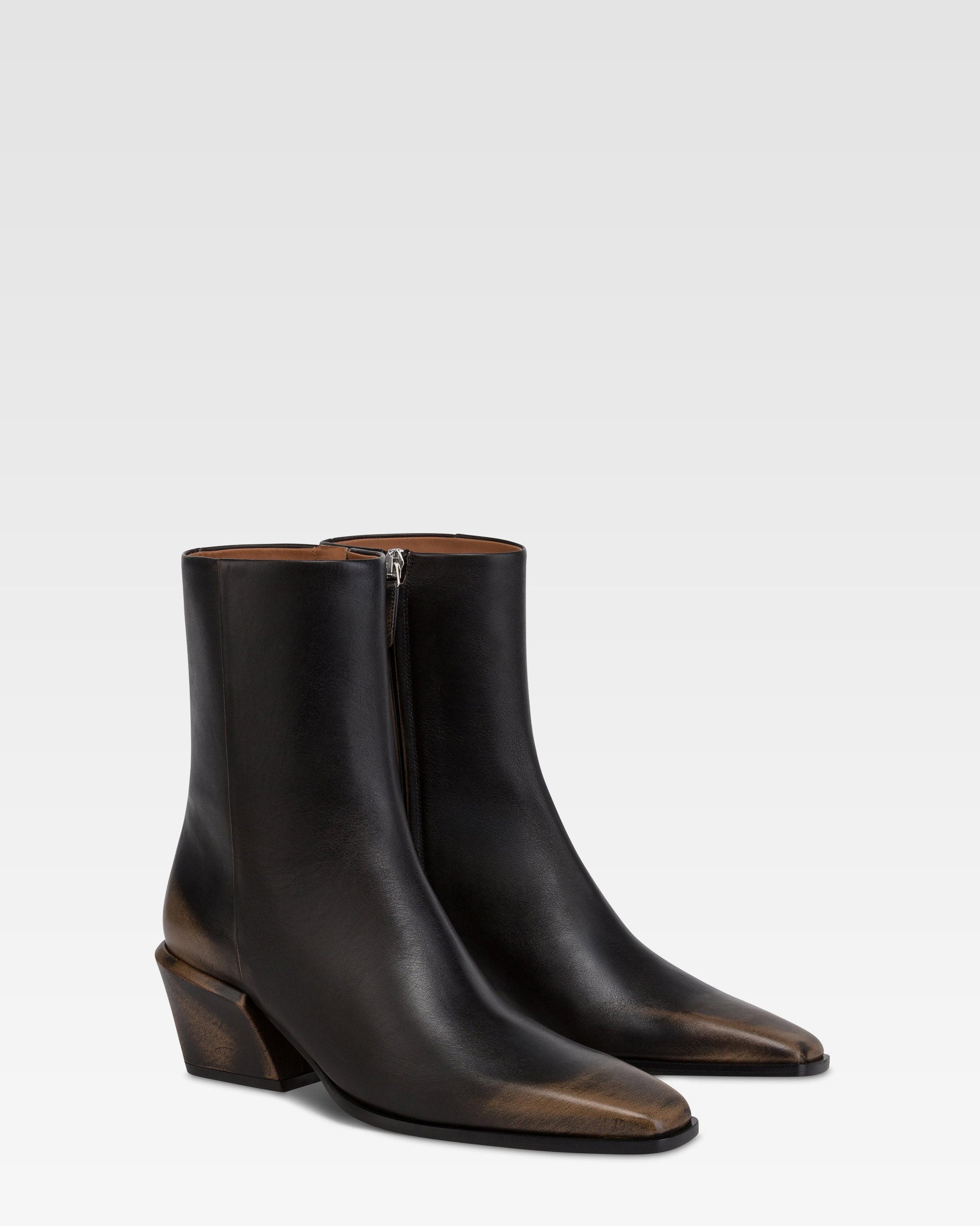 Ankle boots in black brushed leather.