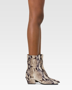 Ankle boots in natural printed python leather.
