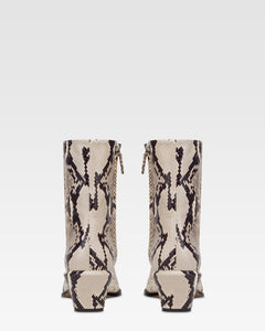 Ankle boots in natural printed python leather.
