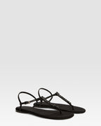 Flat sandals in black crepe satin with stud detailing