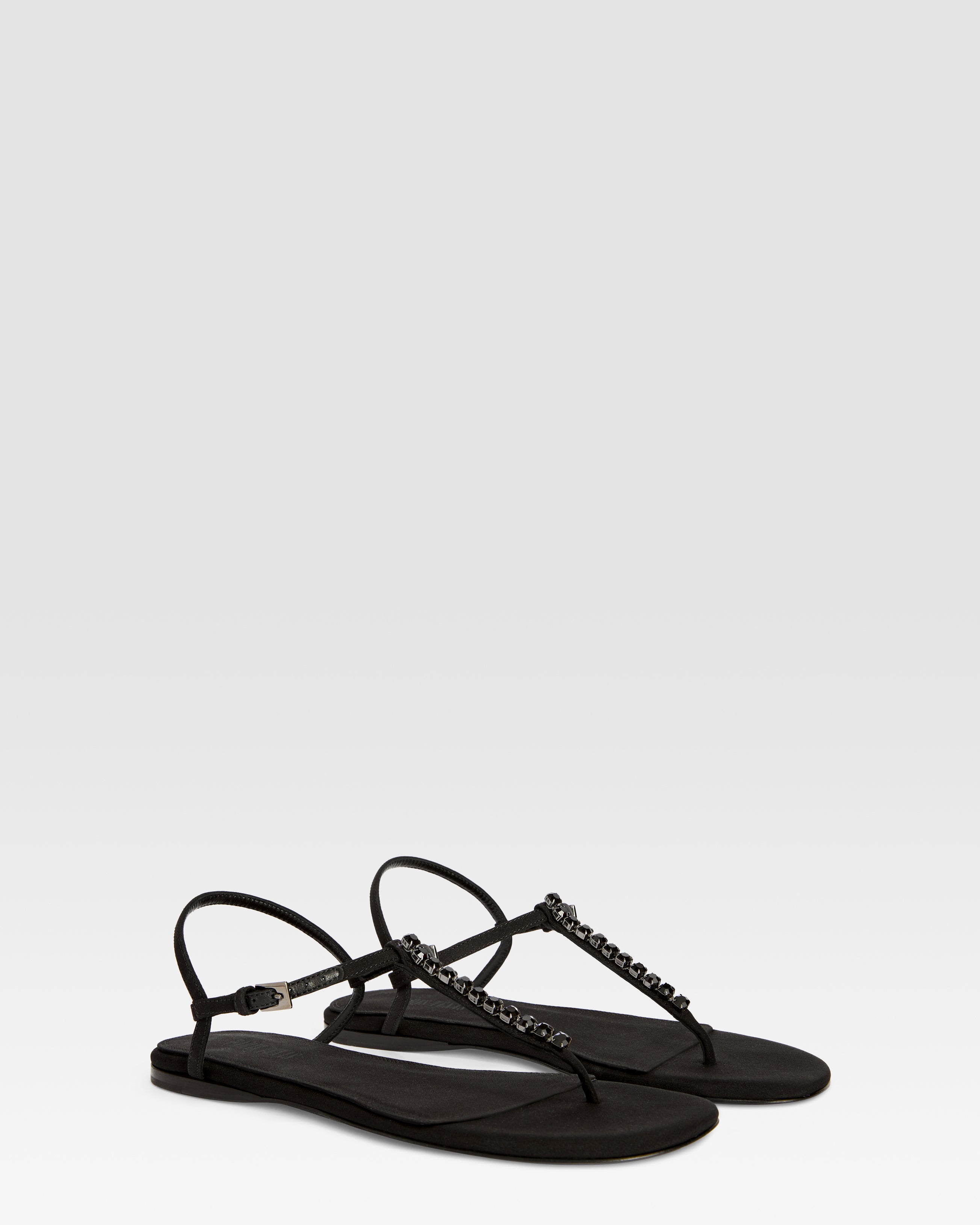 Flat sandals in black crepe satin with stud detailing