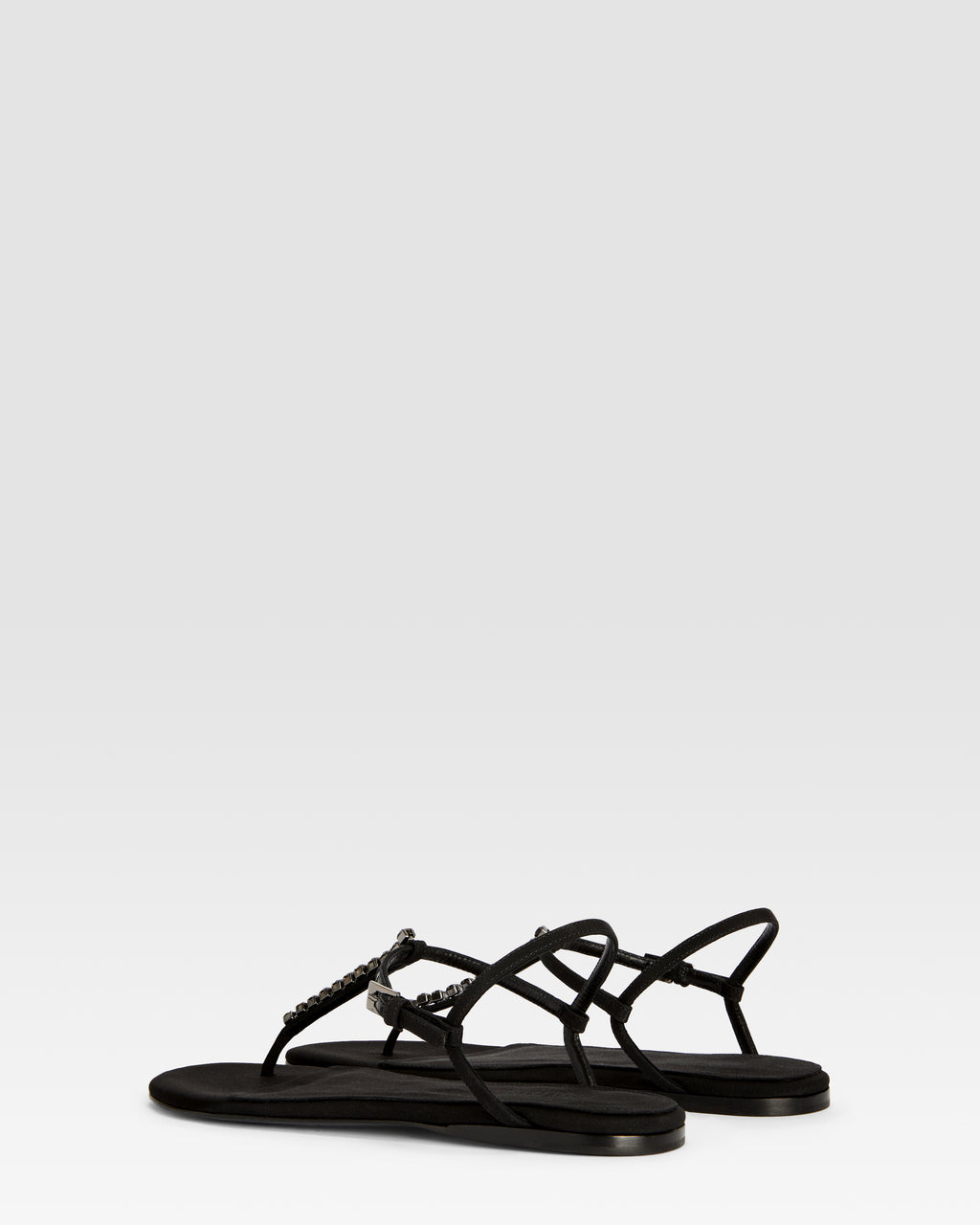 Flat sandals in black crepe satin with stud detailing