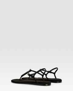 Flat sandals in black crepe satin with stud detailing
