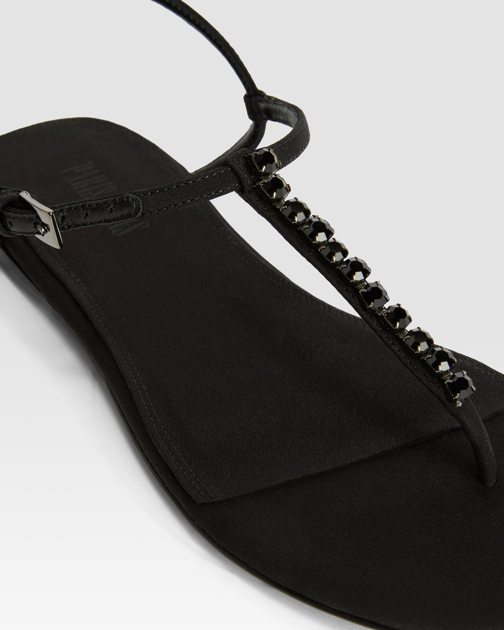 Flat sandals in black crepe satin with stud detailing