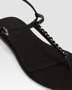 Flat sandals in black crepe satin with stud detailing