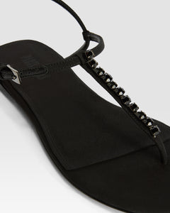Flat sandals in black crepe satin with stud detailing