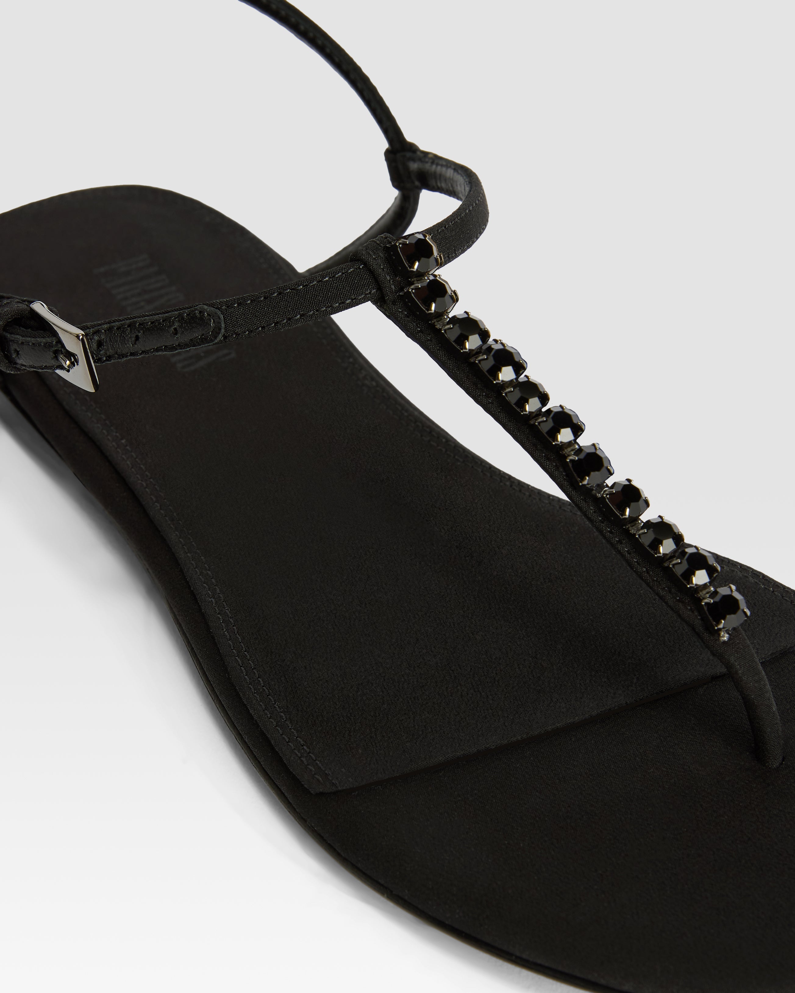 Flat sandals in black crepe satin with stud detailing