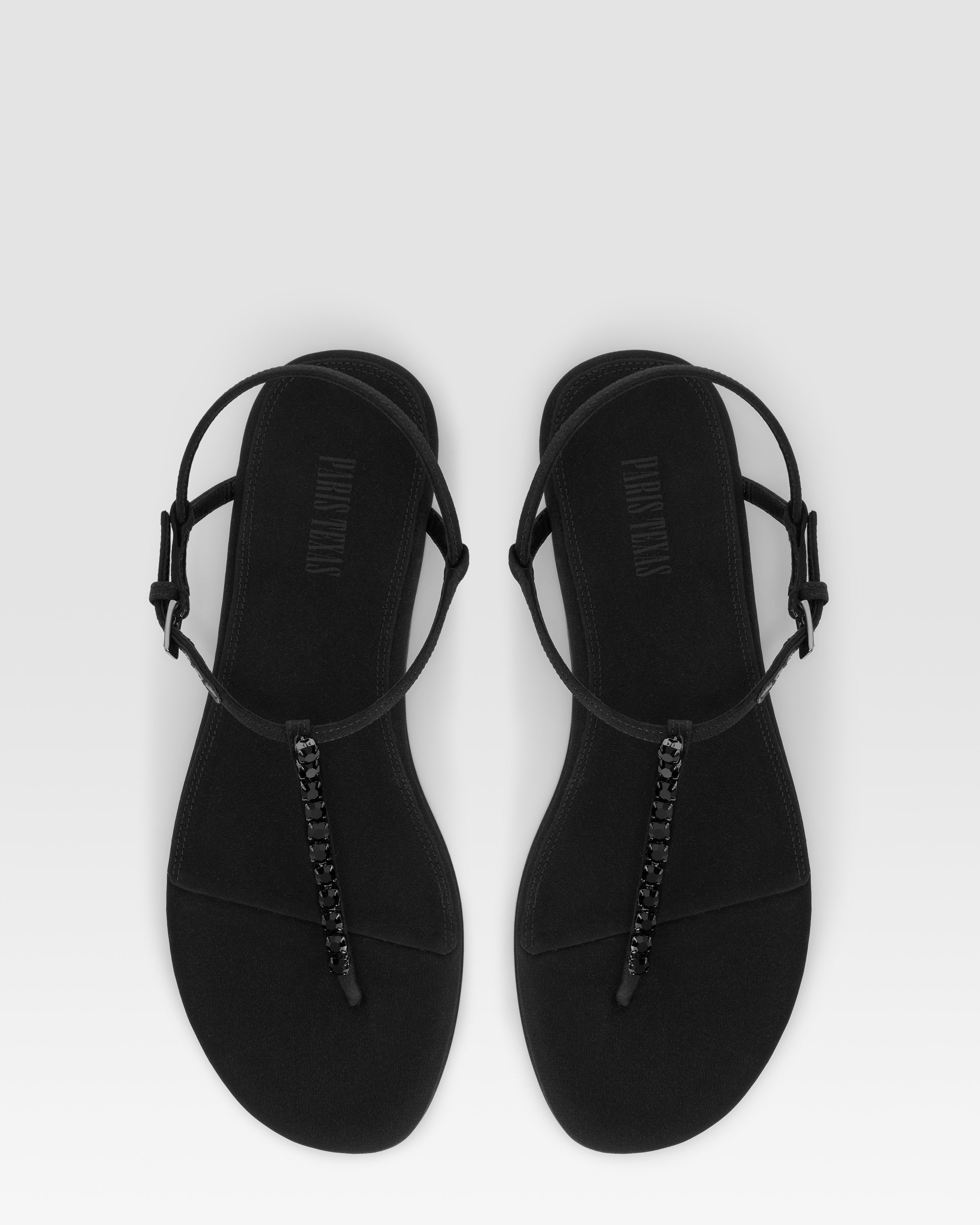 Flat sandals in black crepe satin with stud detailing