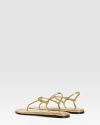 Flat sandals in gold metallic-effect, plisse leather