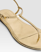 Flat sandals in gold metallic-effect, plisse leather