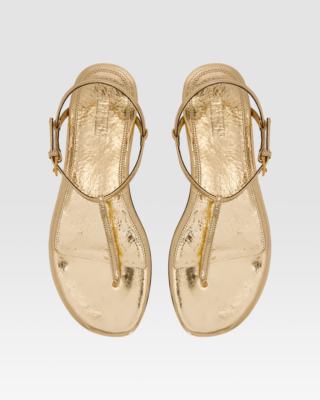 Flat sandals in gold metallic-effect, plisse leather