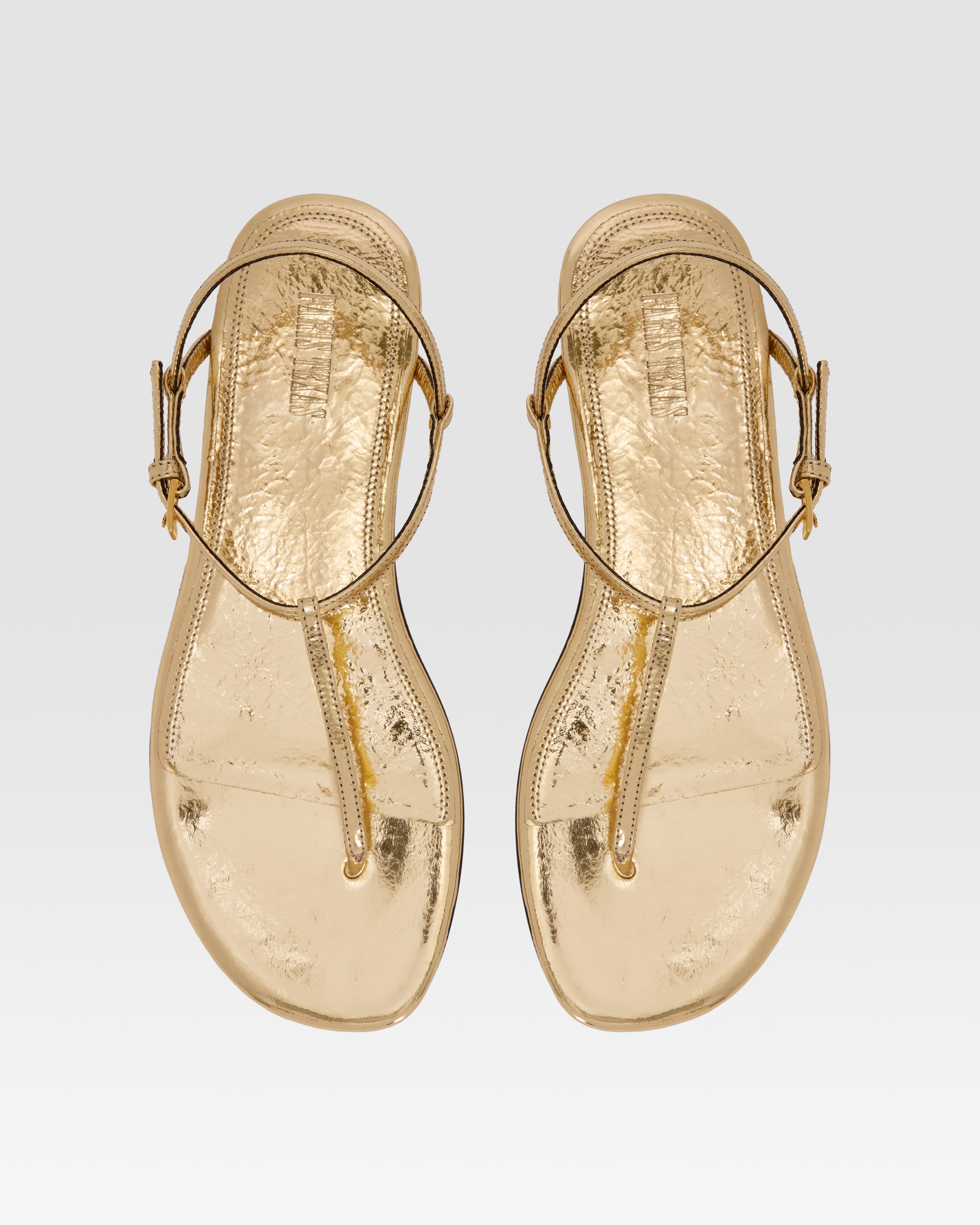 Flat sandals in gold metallic-effect, plisse leather