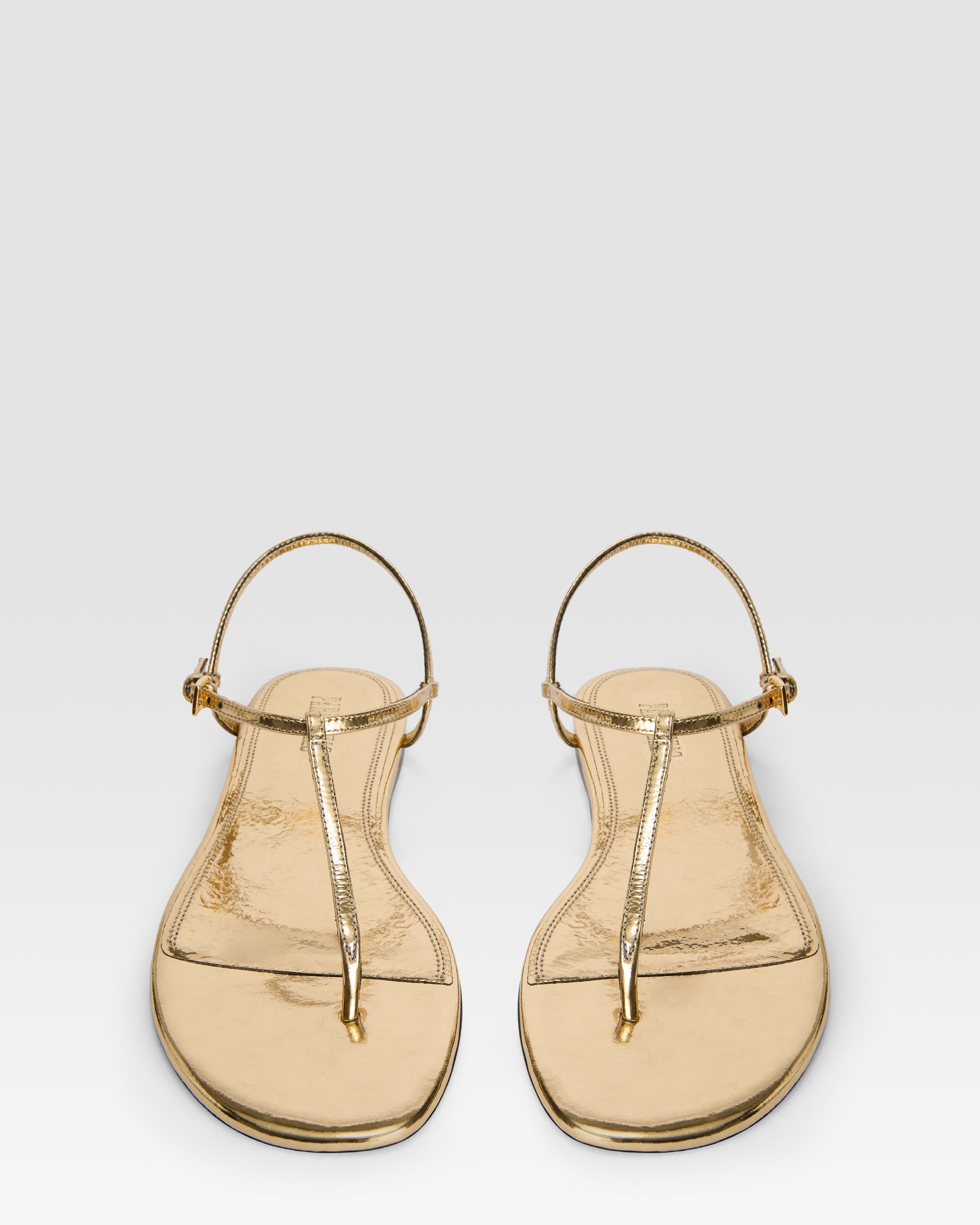 Flat sandals in gold metallic-effect, plisse leather