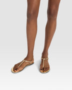 Flat sandals in gold metallic-effect, plisse leather