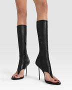 Thong boots in black stretch leather