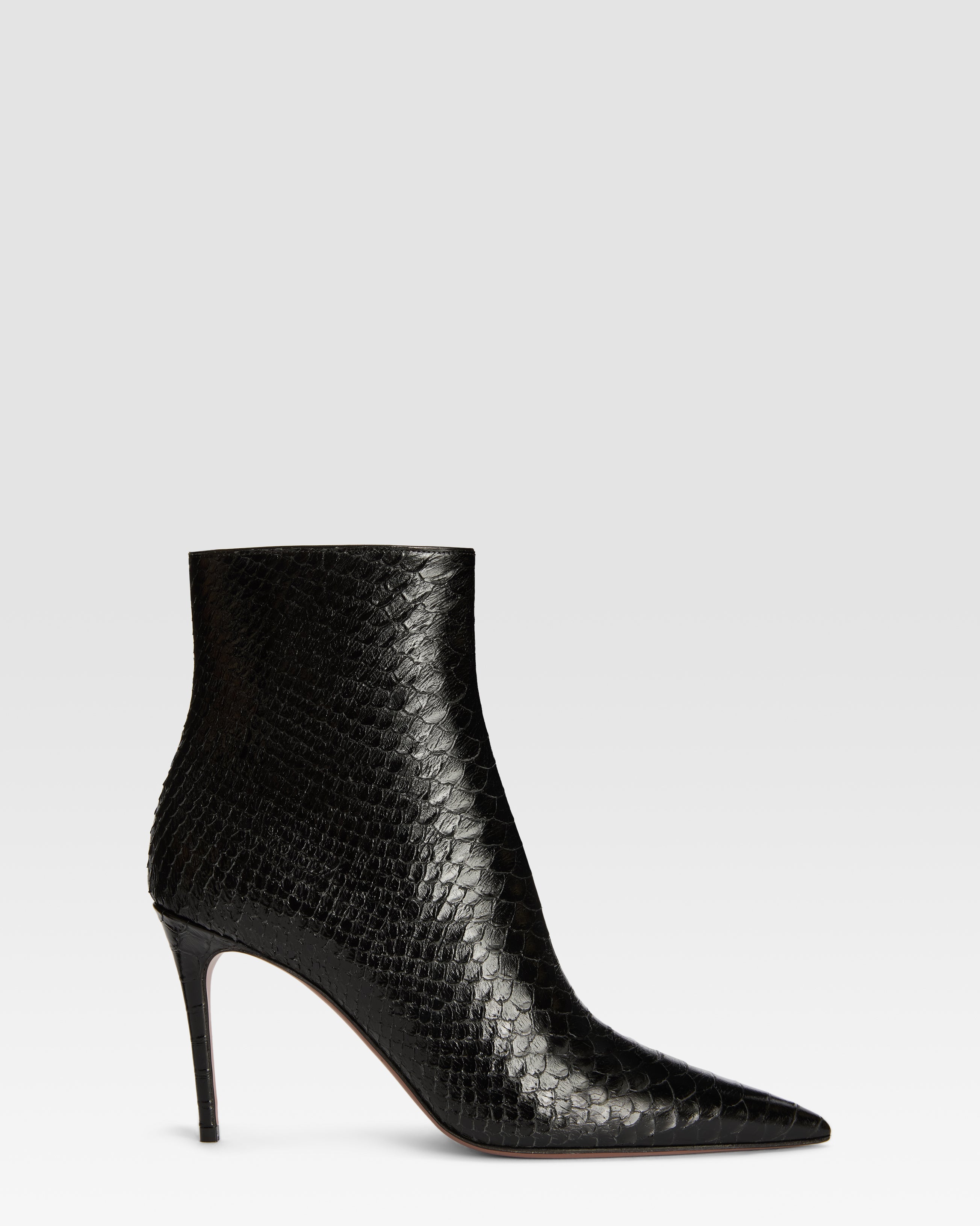Ankle boots in black printed python leather
