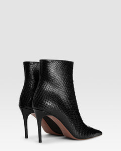 Ankle boots in black printed python leather