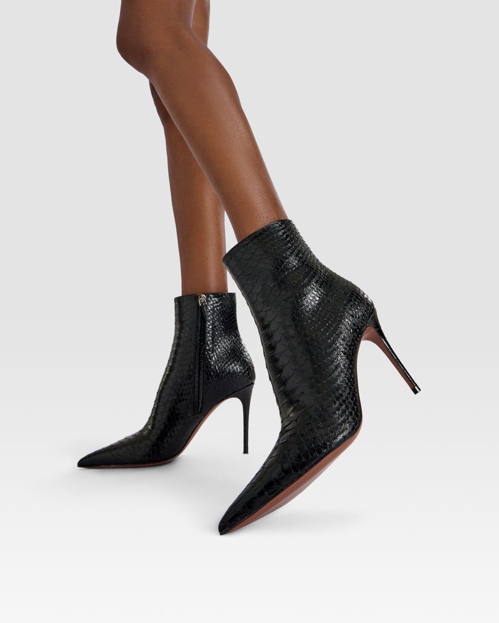 Ankle boots in black printed python leather