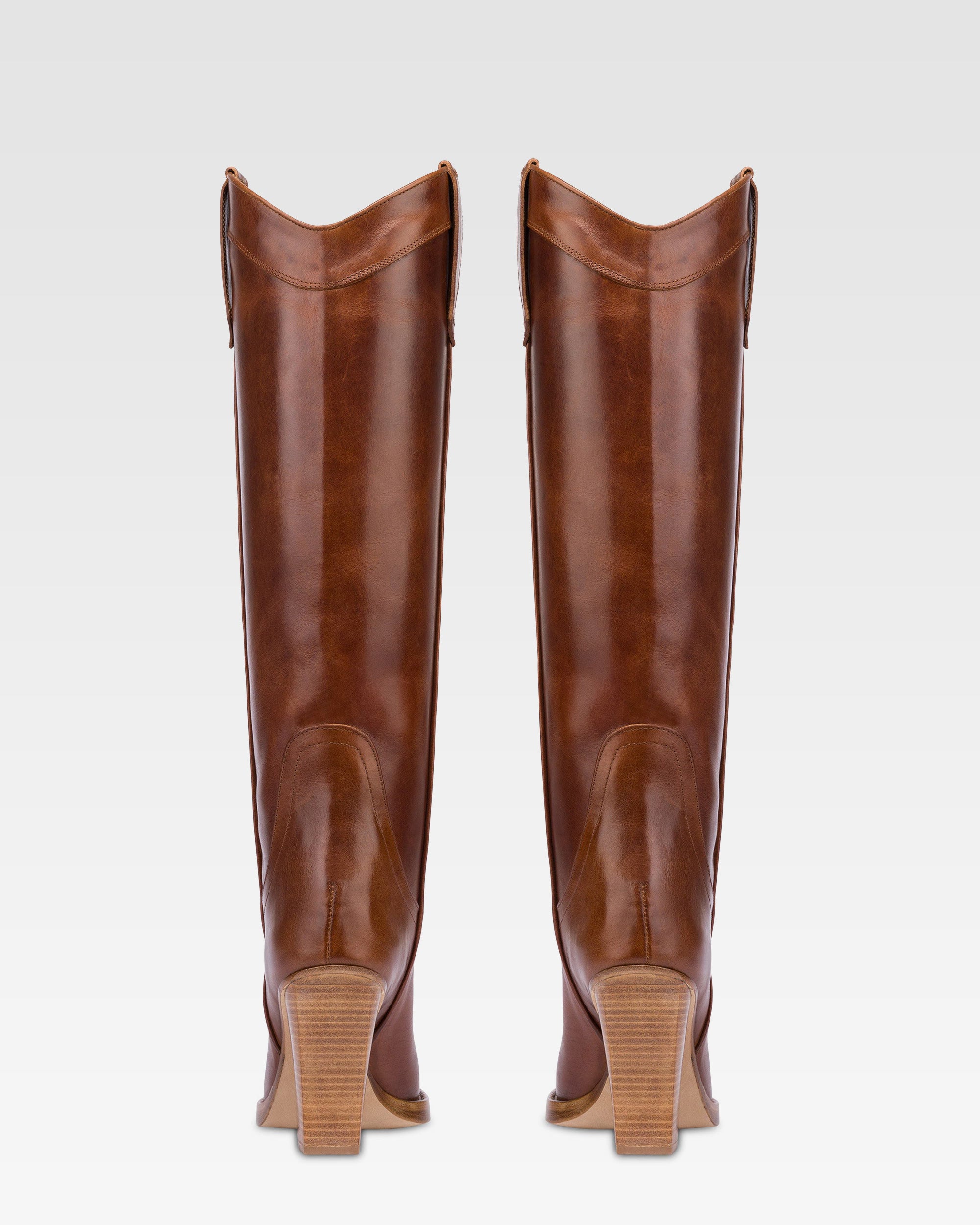 Pointed knee-high boots in shiny vintage leather