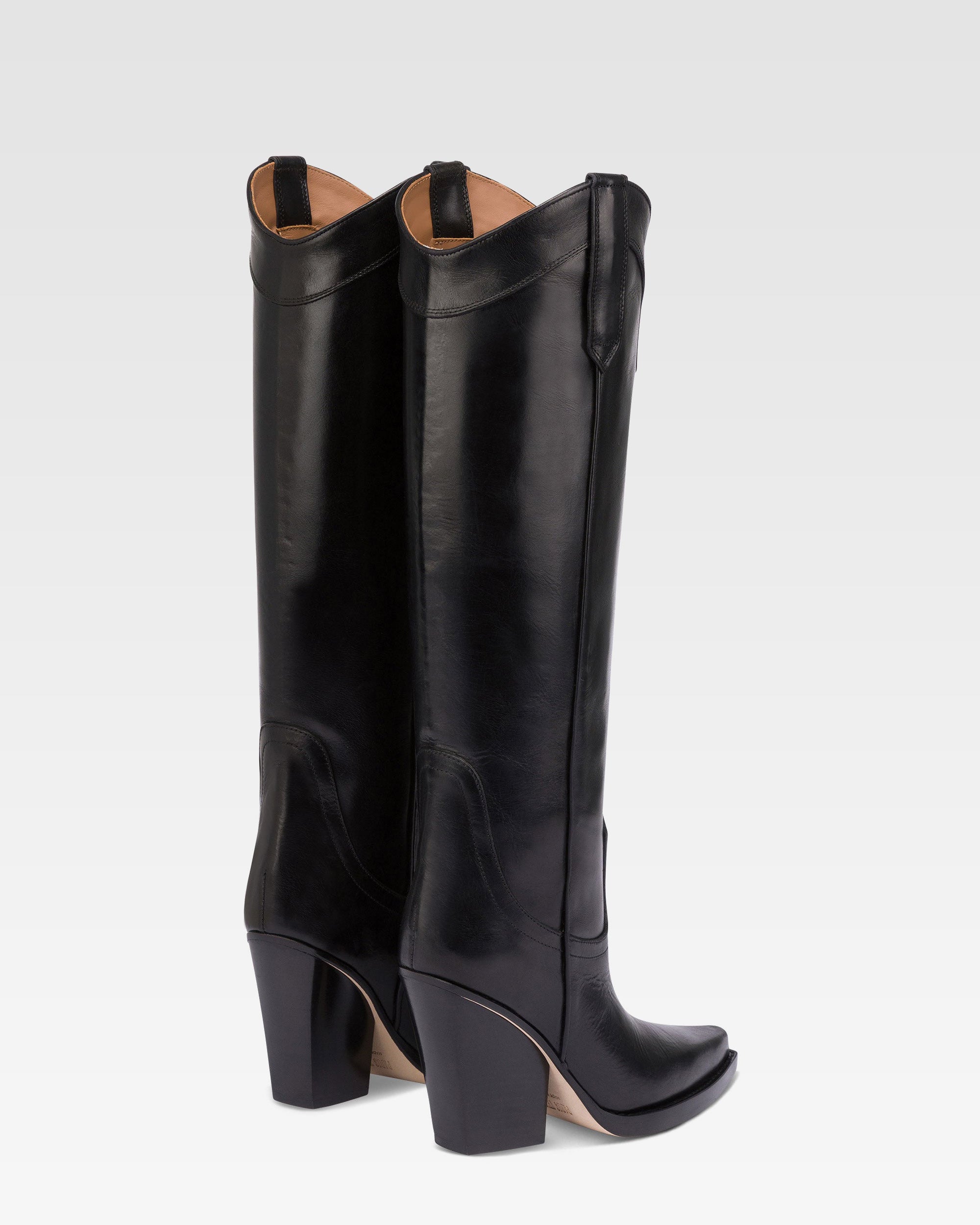 Pointed knee-high boots in black shiny vintage leather