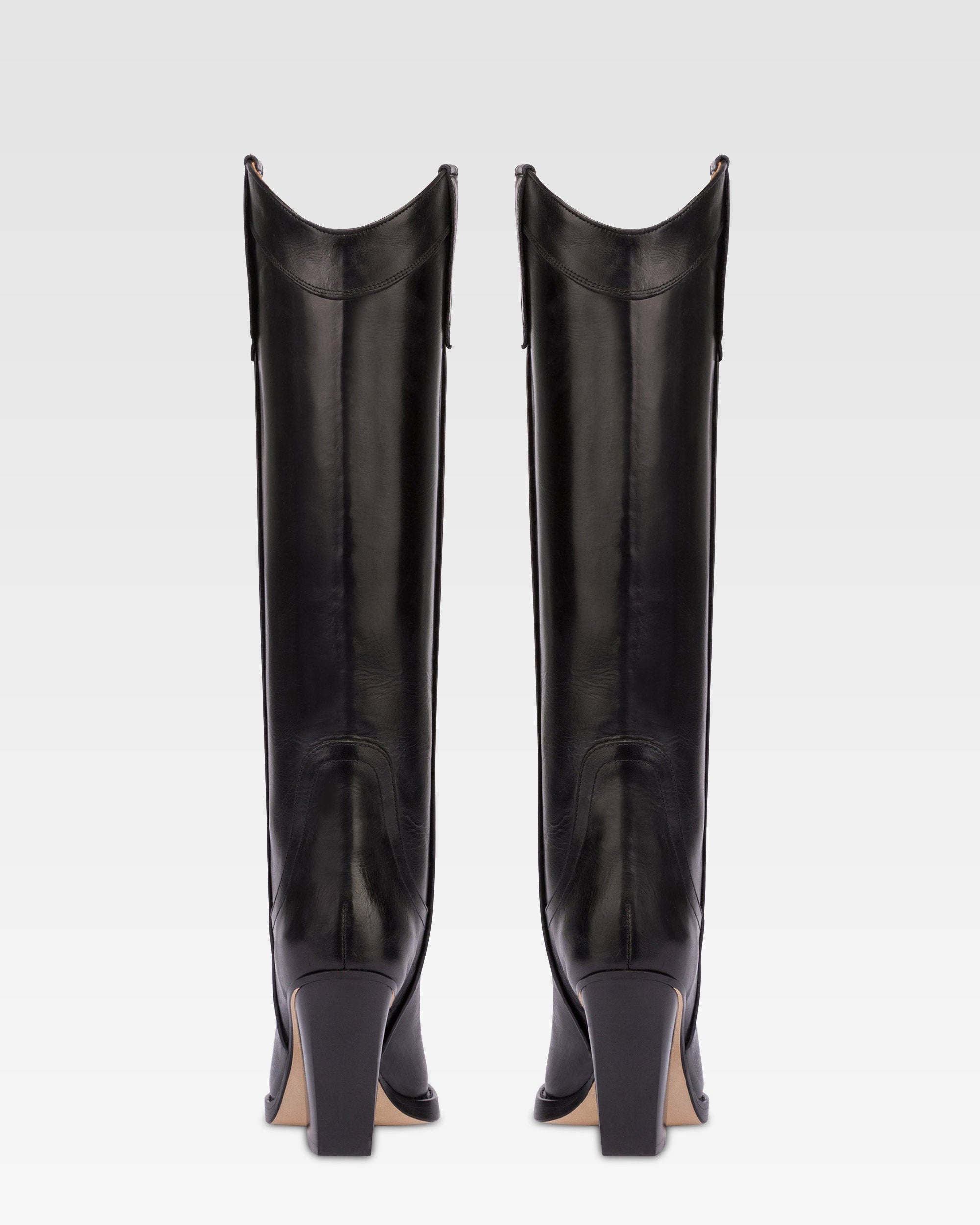 Pointed knee-high boots in black shiny vintage leather