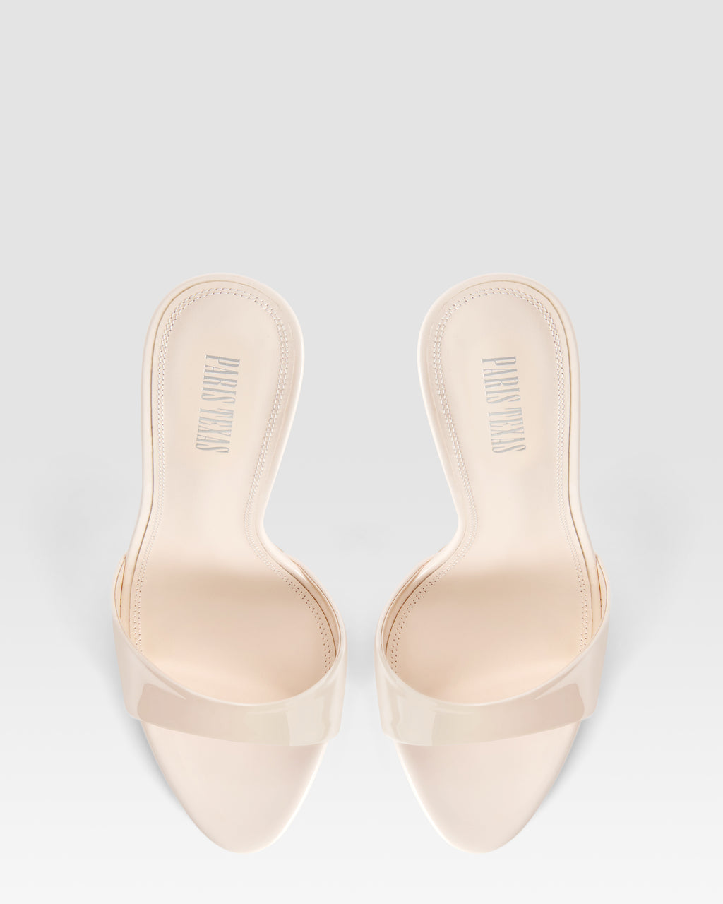 Mules in ivory patent leather